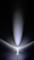 A single LED light shines in a dark room, with the light radiating upwards in a conical shape and creating a subtle blue glow.