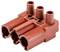 Red electrical system plug with three round connectors and complex housing structure, used for connecting electronic components.