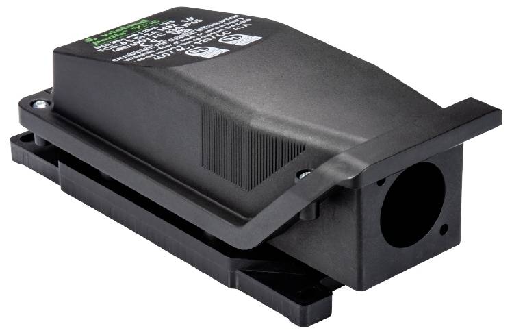 Black electrical transformer with cable connection and green labelling on top of the cover.