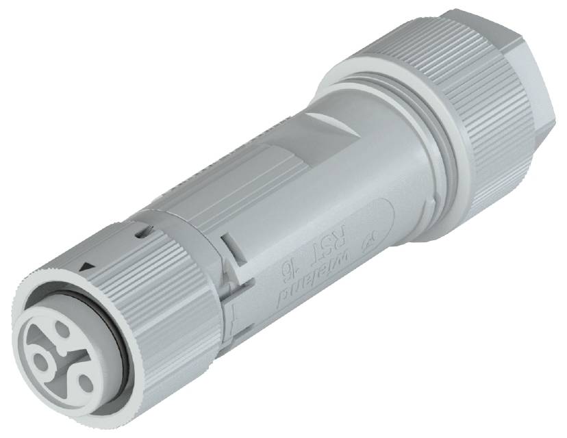 Grey cylindrical connector in close-up, showing the mechanical construction with grooves and connection sides.