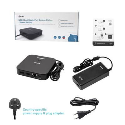 A USB-C docking station with two DisplayPort ports, power supply and country-specific adapter. In the background, the packaging and quick start guide.