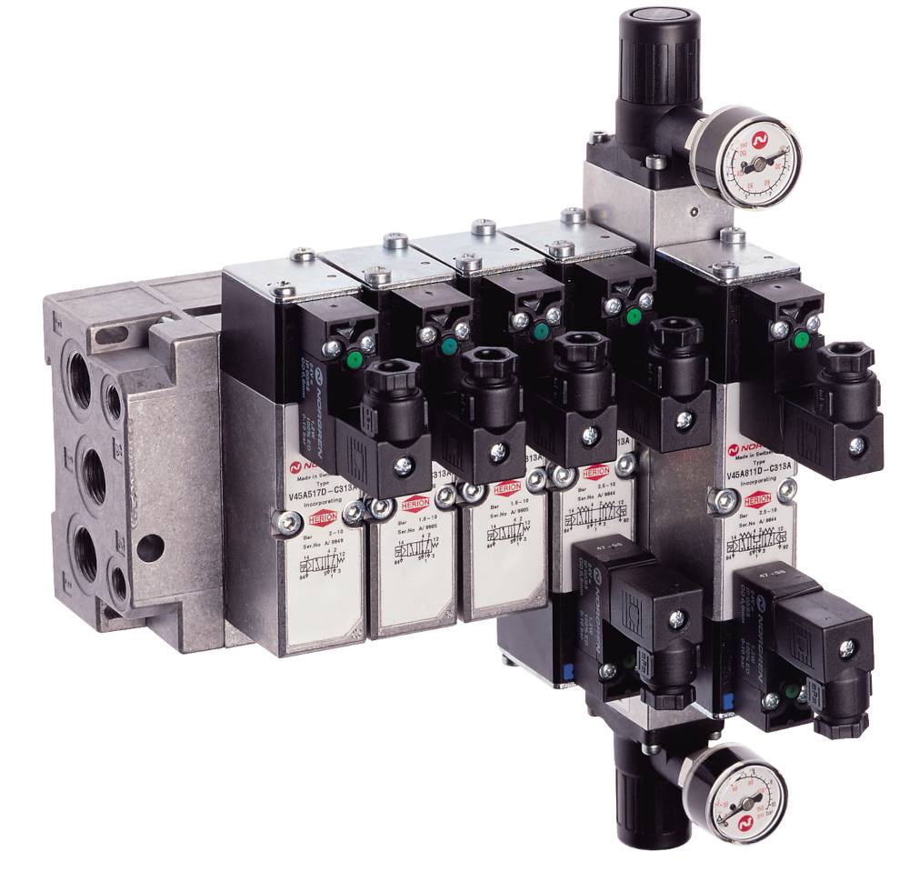 Industrial valve block with multiple valves and pressure gauges, used for pressure control in a pneumatic or hydraulic system.