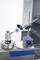 A precision measuring instrument is measuring the diameter of a cylindrical metal part. It is positioned on a laboratory bench in a technical laboratory.