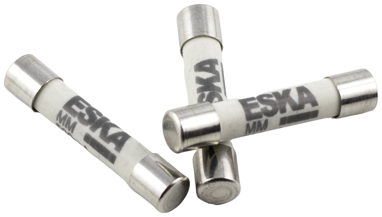 Three white cylindrical fuses with 'ESKA MM' printed on each, arranged in a slight stack.