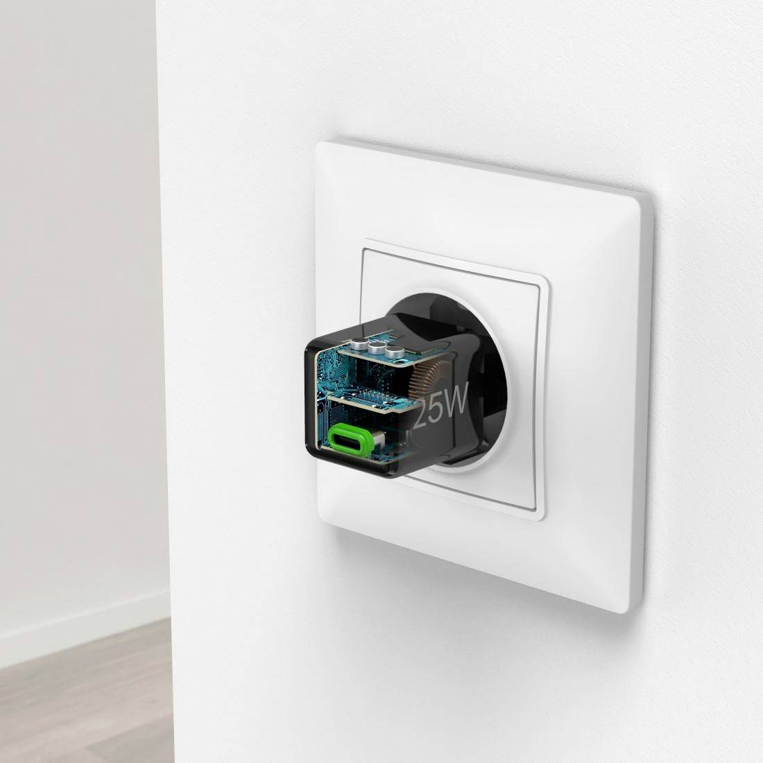 Socket with a transparent charger revealing internal circuitry, mounted on a white wall. The adapter displays a '25W' rating.