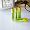 Four yellow and green AA batteries by the brand Intenso are standing on a white table next to a digitally displayed time.
