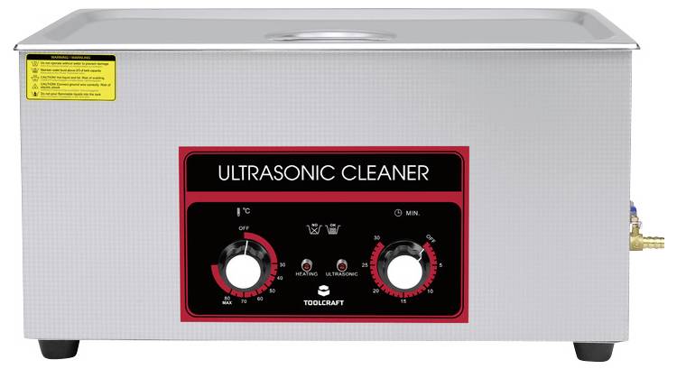 Ultrasonic cleaner with control elements and indicators for timer and heating functions. Silver casing with black front panel.