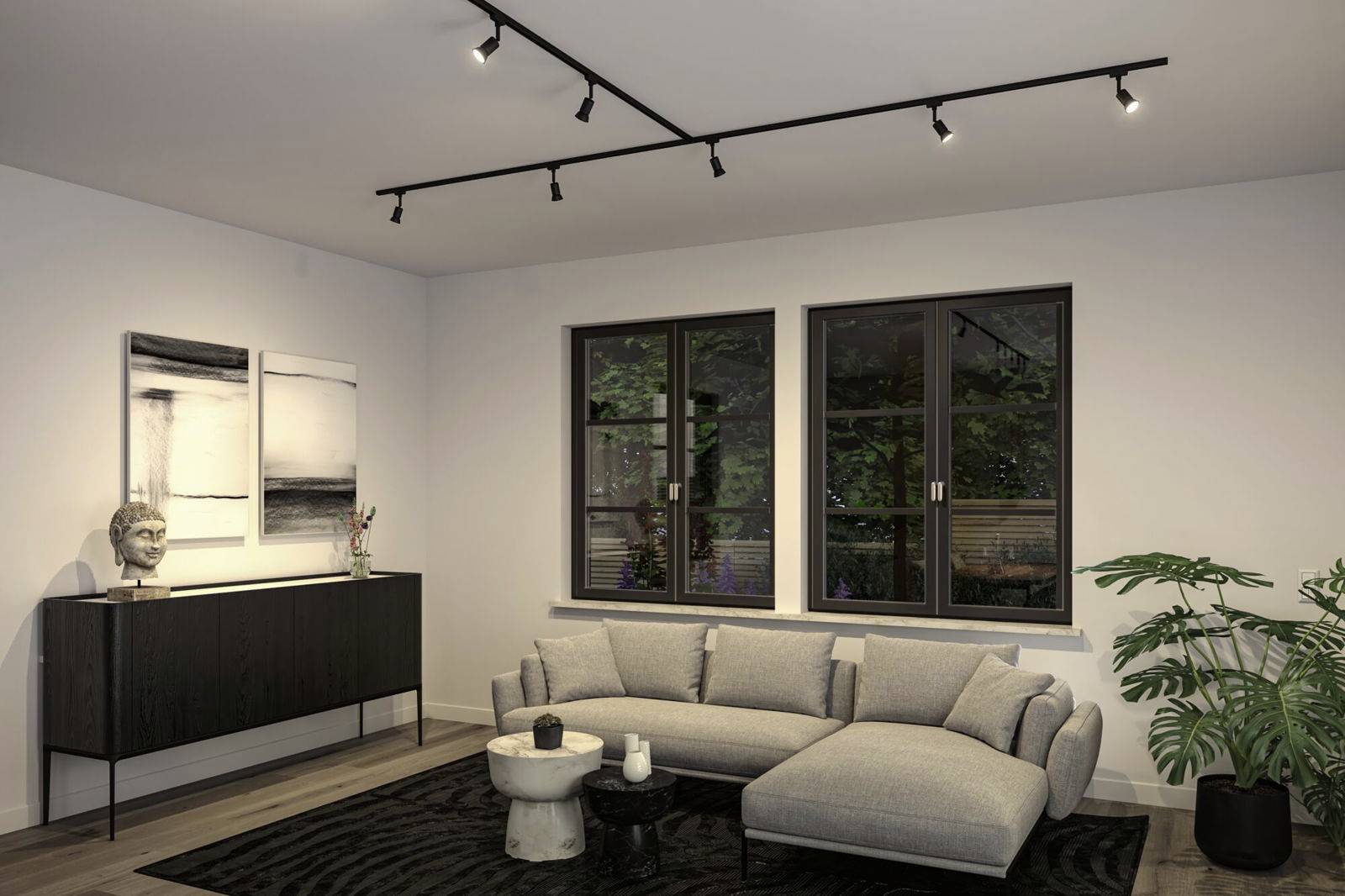 Modern living room with a beige sofa, black rug and sideboard. Pictures and a plant as decoration, window with an outside view.