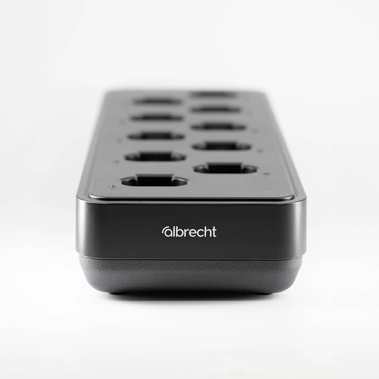 A black multi-socket extension with ten plug sockets on a white surface, featuring the 'albrecht' branding at the front.