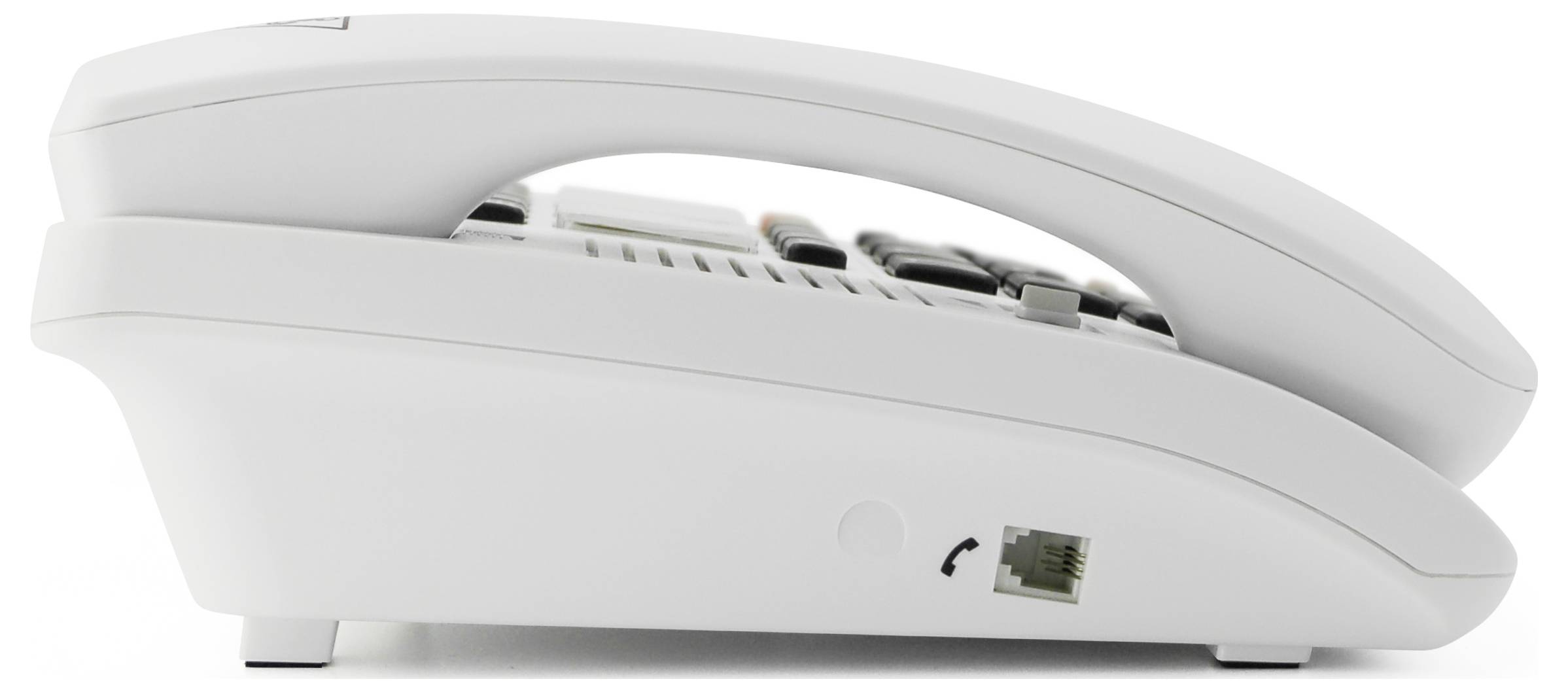 A white landline telephone viewed from the side, with a visible handset cradle and a connection for the telephone cable on the underside.