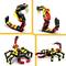 Top: Two different LEGO creations of a snake with yellow fangs. Bottom: Two LEGO scorpions with movable pincers.