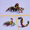 Three Lego Creations: At the top, a black and red scorpion; below left, a comparable scorpion; below right, a black and red robot.