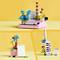 Lego models of a typewriter, vase, and notepad against a yellow background. Creative, colourful designs with floral motifs.