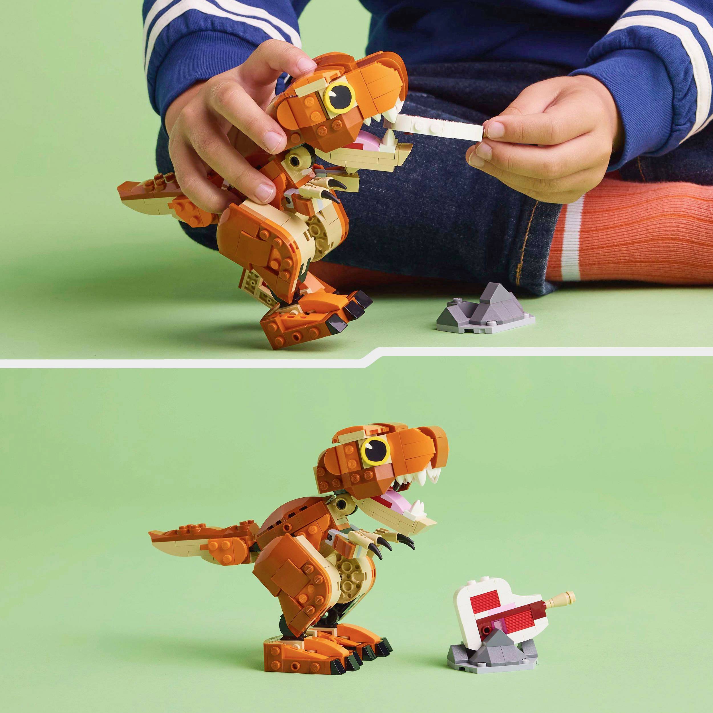 A child is playing with an orange dinosaur model made of building blocks, which shows a glowing red tongue.