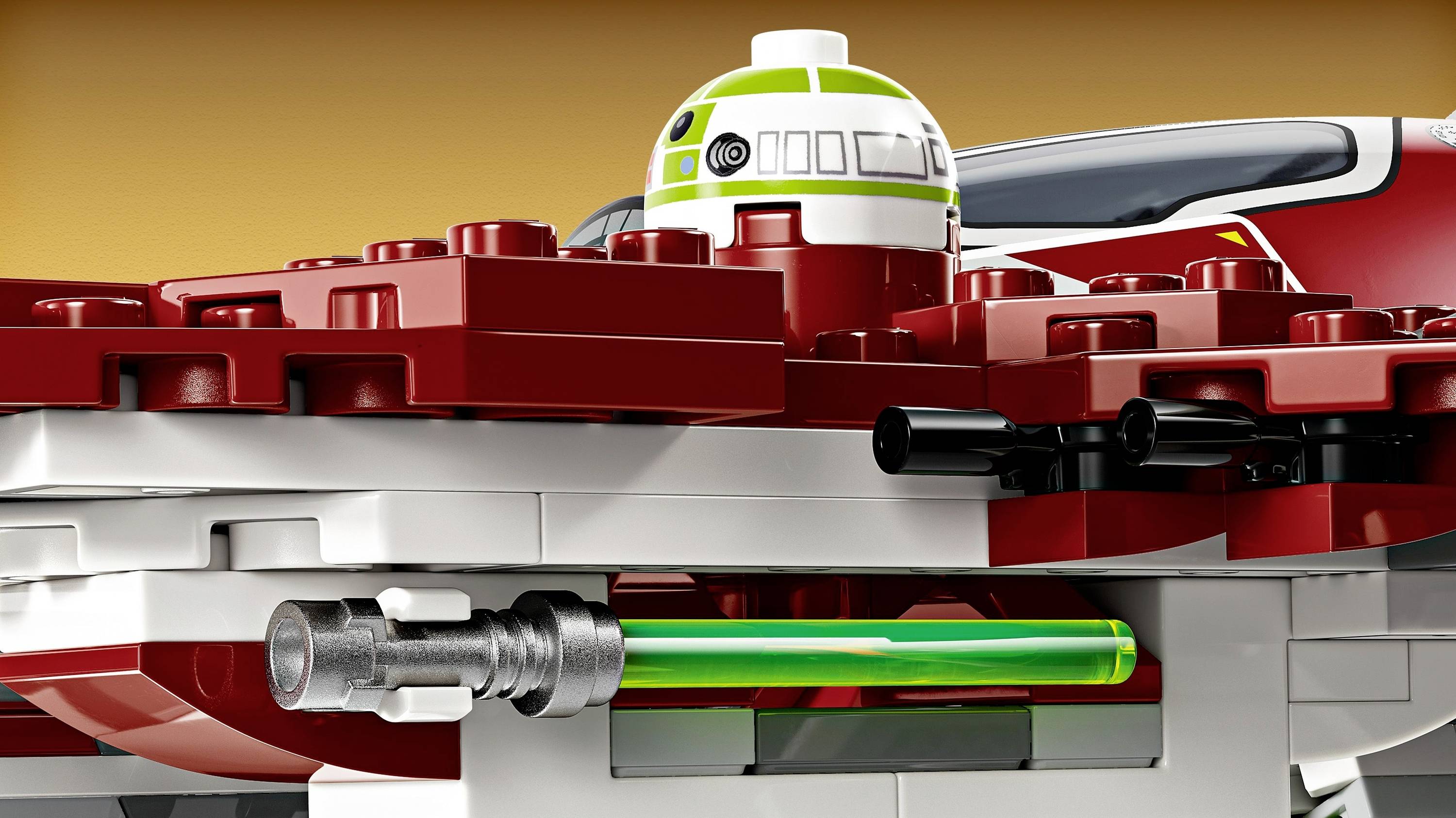 A red and white LEGO spaceship with a round cockpit and a green lightsabre. Background in brown tones.