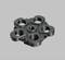 A black, round component with five symmetrically arranged holes, resting on a grey background.