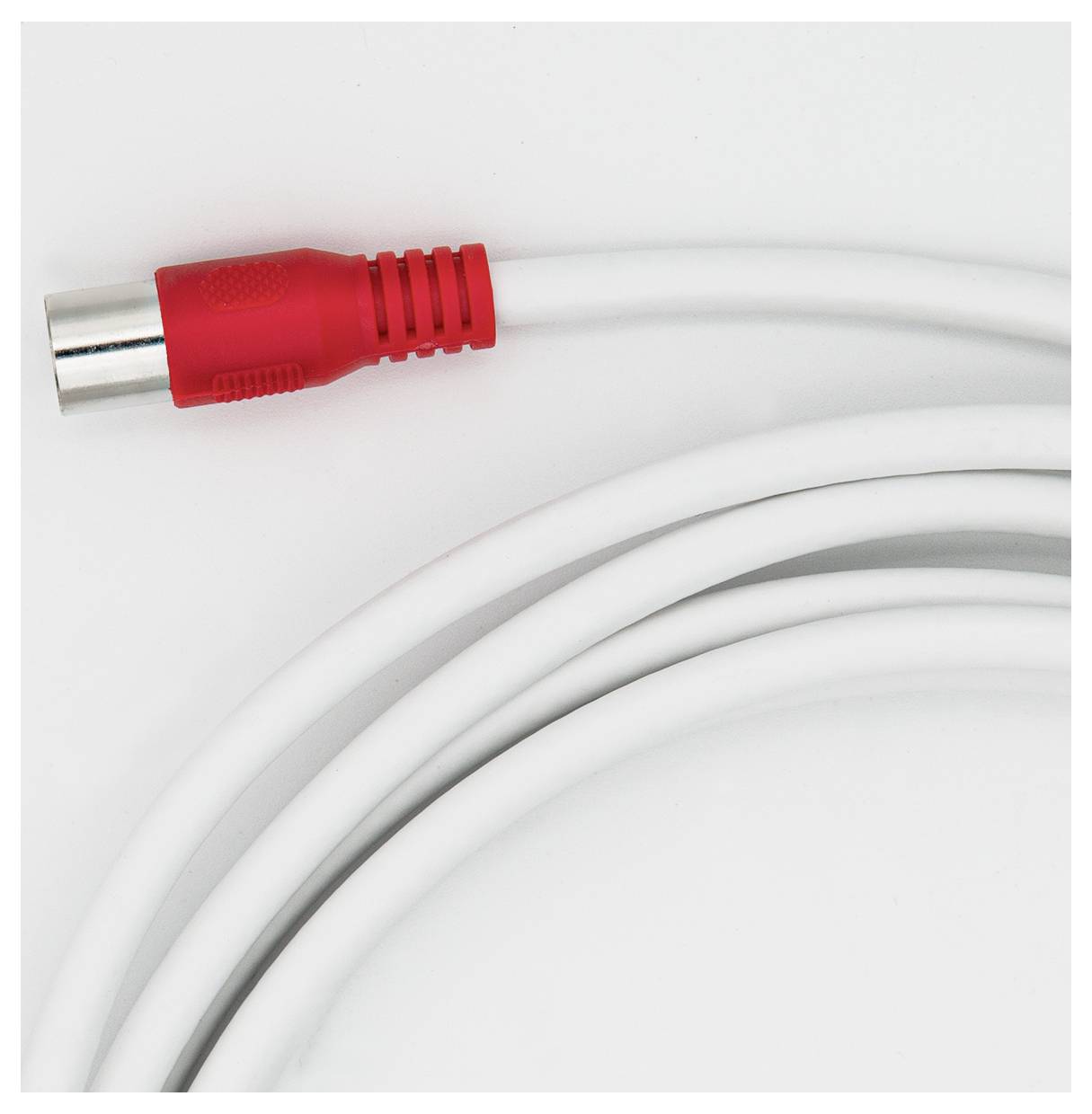 A white audio cable with a red and silver plug is lying on a white surface.