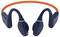 Black bone conduction headphones with an orange neckband, viewed from the front.