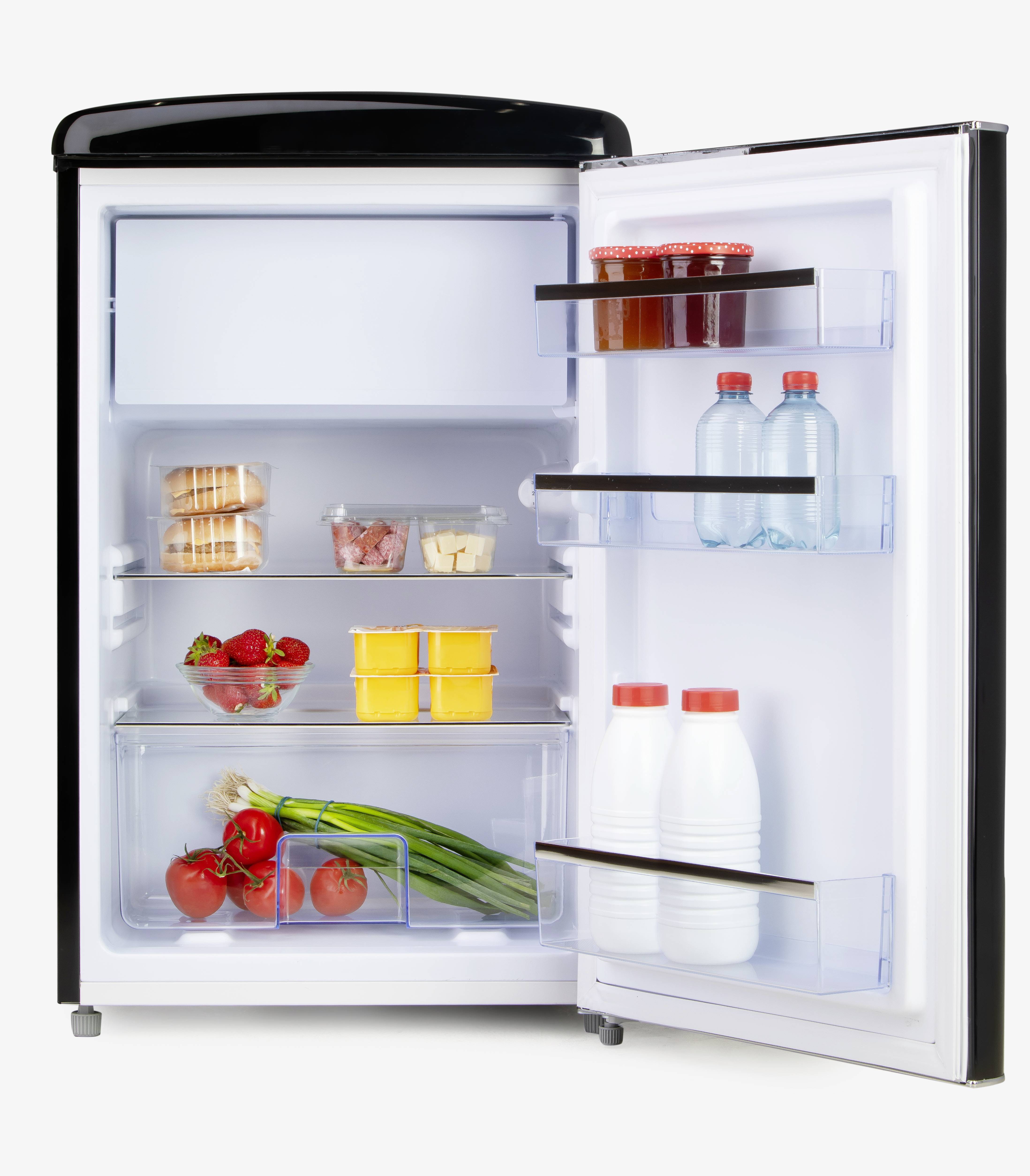 An open fridge reveals bottles, tins, fruit, vegetables and dairy products arranged on different shelves.