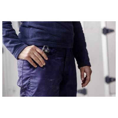 Close-up of a person in dark work clothes with a tape measure clipped to their pocket.