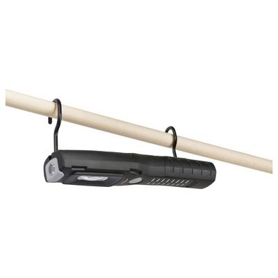 Black flashlight or lantern hanging from a wooden rod by two hooks, with a hand crank on one end.