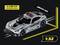 'Model vehicle at 1:32 scale, silver AMG safety car, dimensions 14.5 x 6.5 x 4.8 cm. Black spoiler and red lights.'