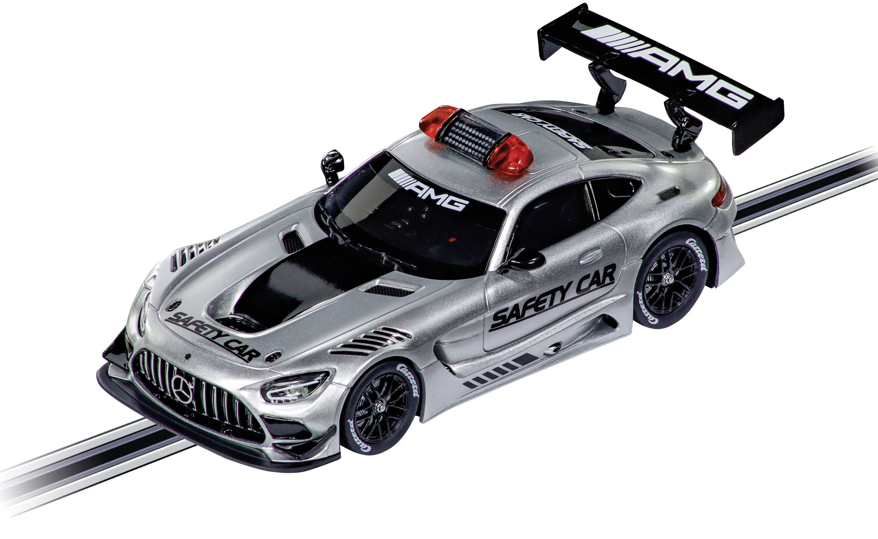 Silver model racing car on a track with 'Safety Car' and 'AMG' markings, fitted with a prominent rear spoiler.