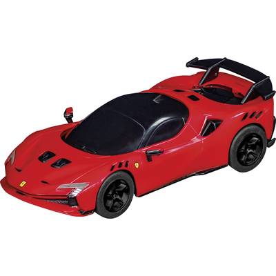 A red sports car with an aerodynamic design and a large rear spoiler. The car is standing on a black surface.