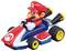 A toy character in a red outfit sits in a toy racing car with yellow wheels, ready to drive.