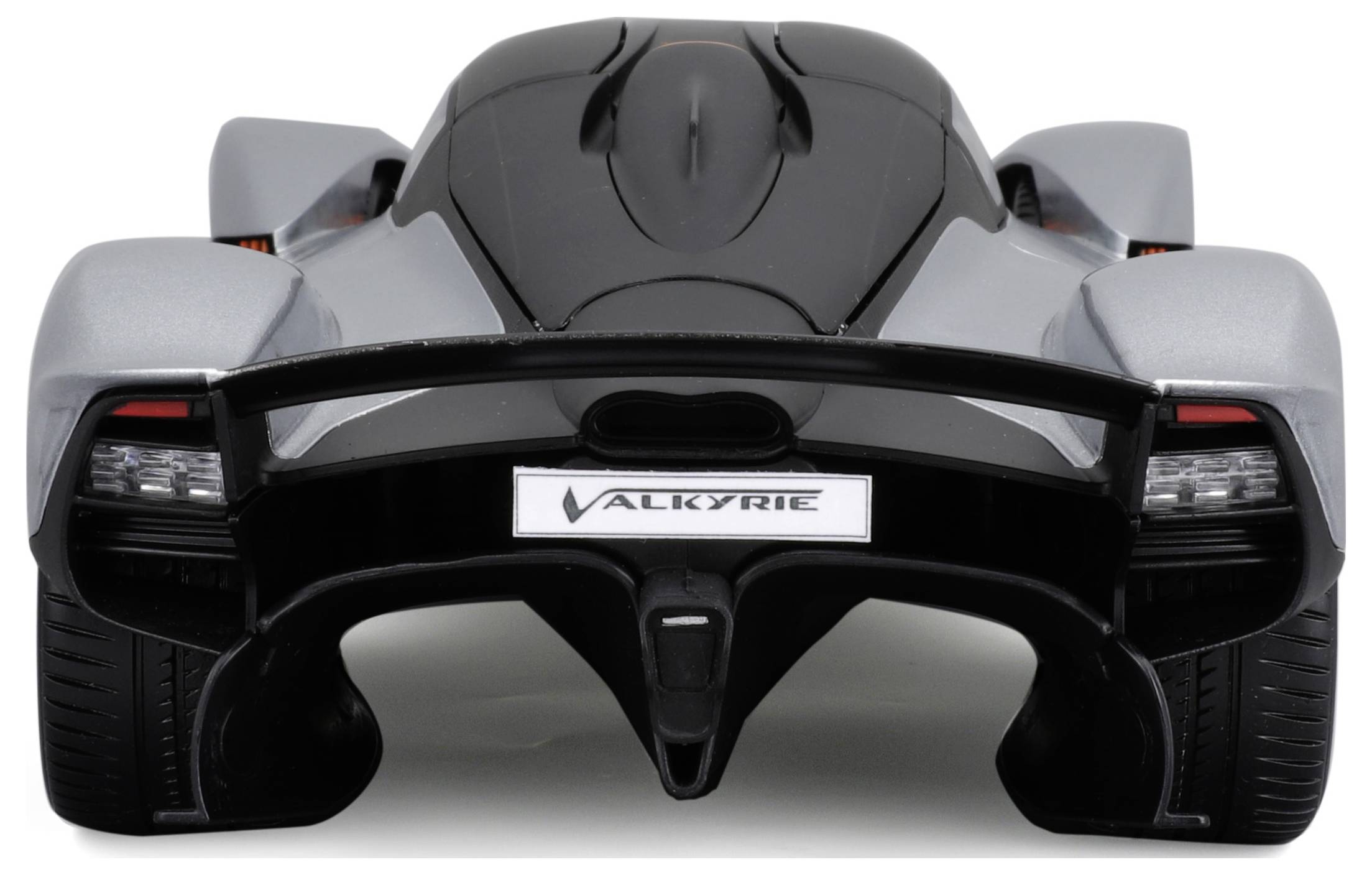 Rear view of a grey sports car with pronounced rear design and the word 'Valkyrie' on the number plate.