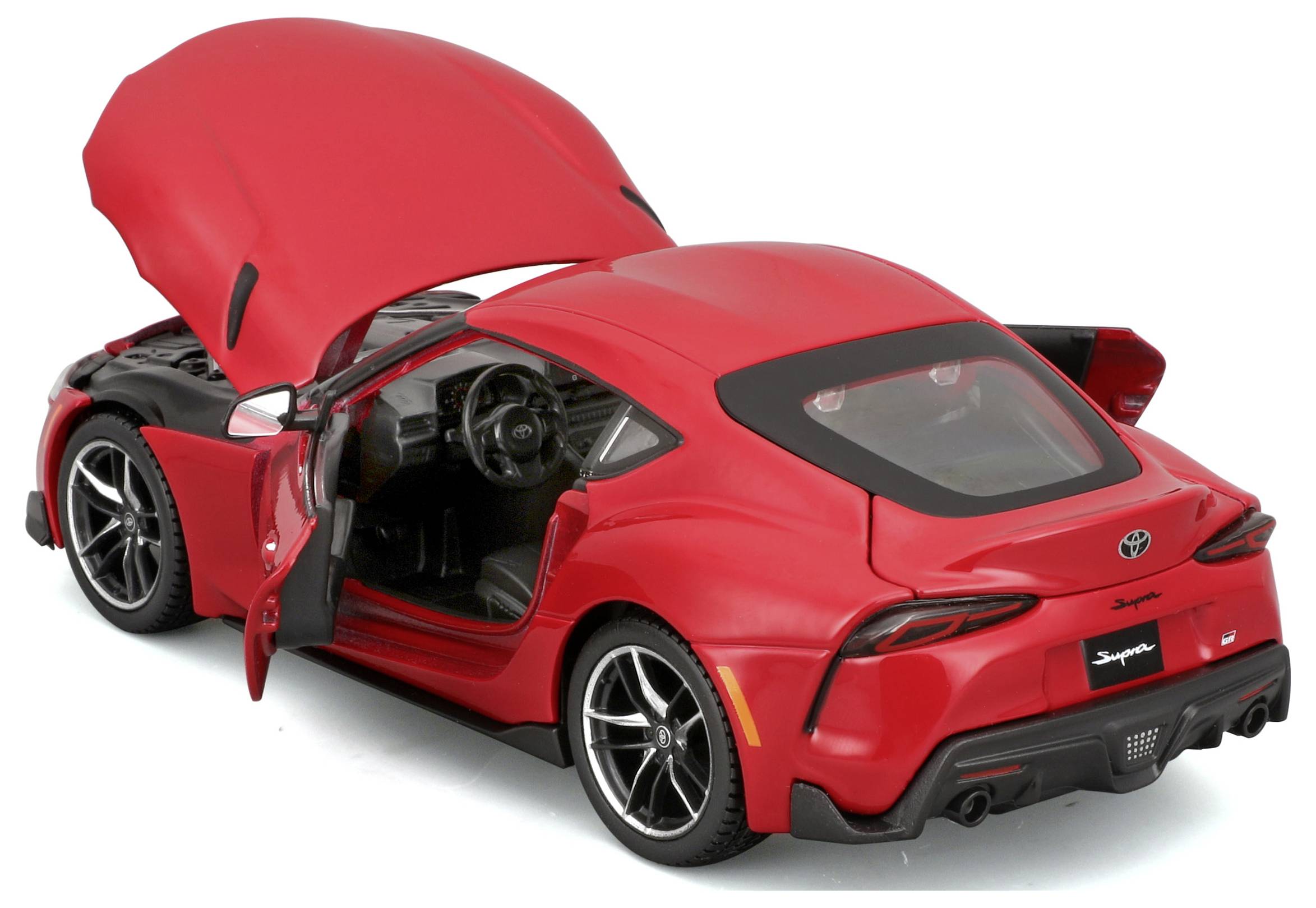 Red model car with open doors and bonnet, revealing details of the interior and engine. Primary focus on vehicle design.
