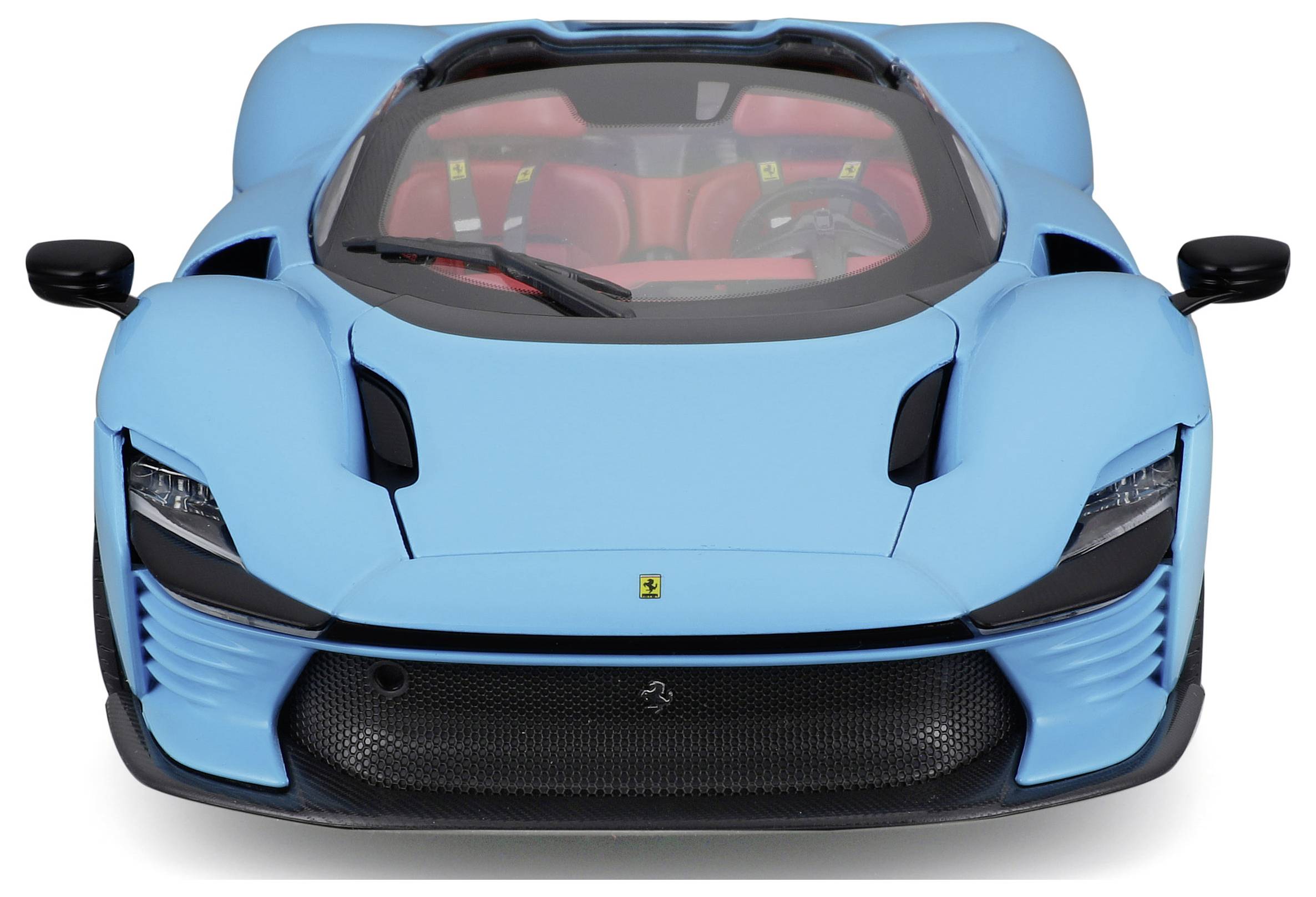 A blue sports car with an open top, viewed from the front. Red interior visible through the windscreen.