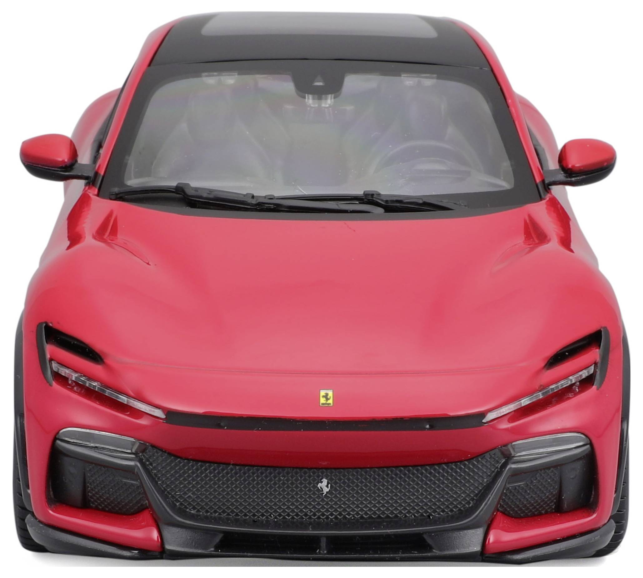 Red car viewed from the front, modern sporty design, black roof and front grille with a small emblem in the centre.