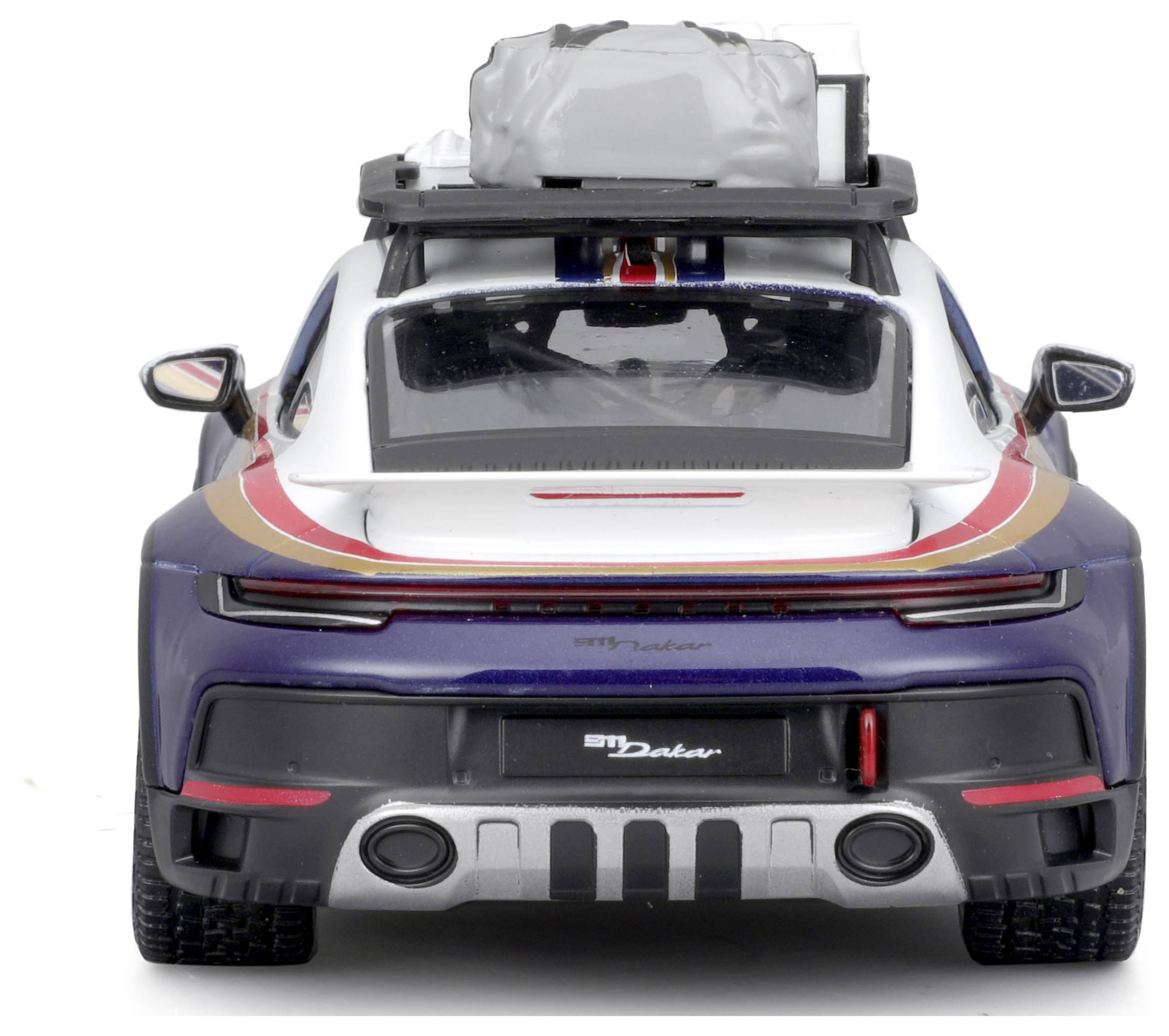 A model car with a roof rack and two bags on top, showing the rear view of a sports car in blue and white with red accents.