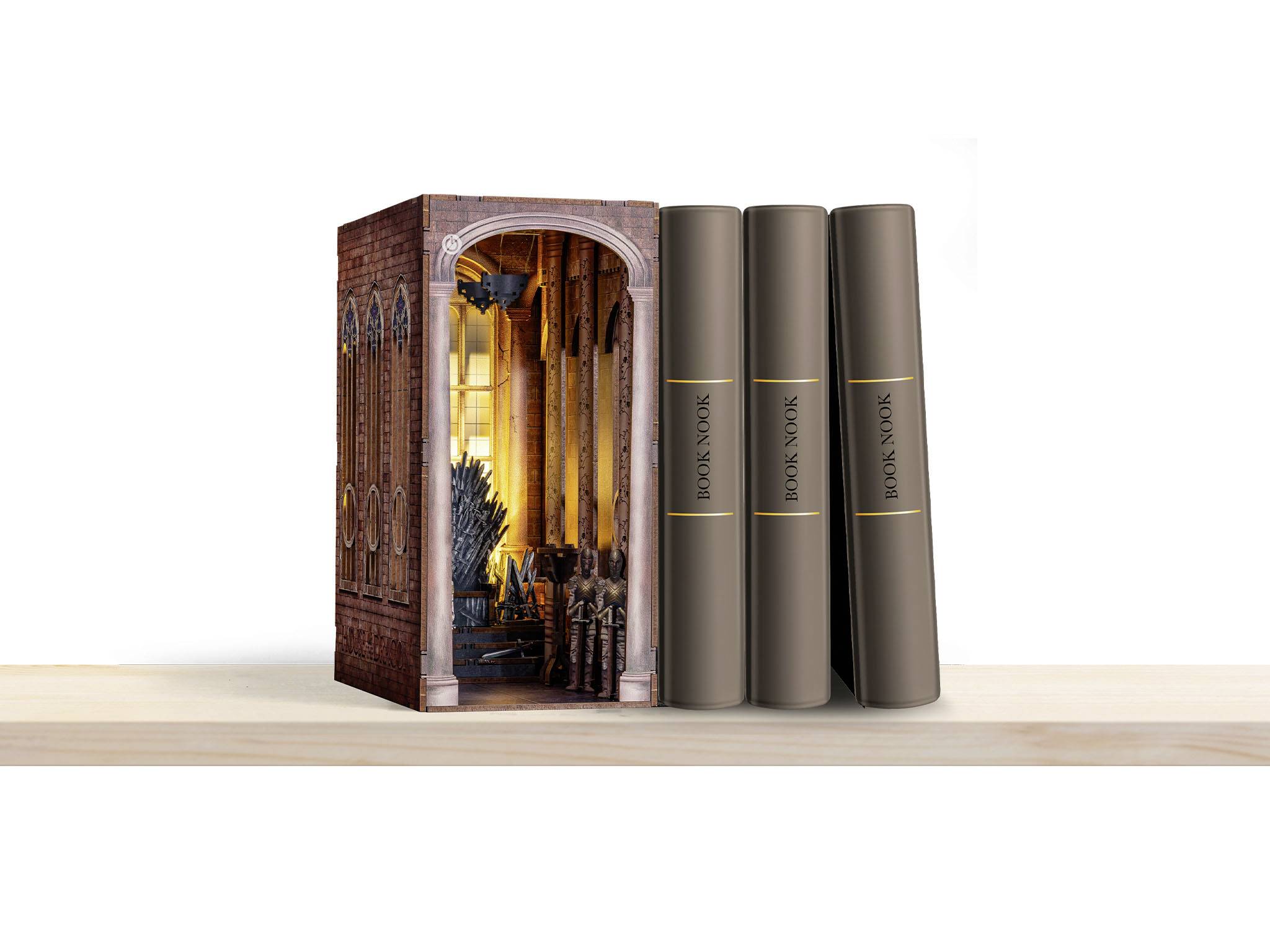 Three books with dark brown covers stand next to a decorative box depicting a medieval hall.