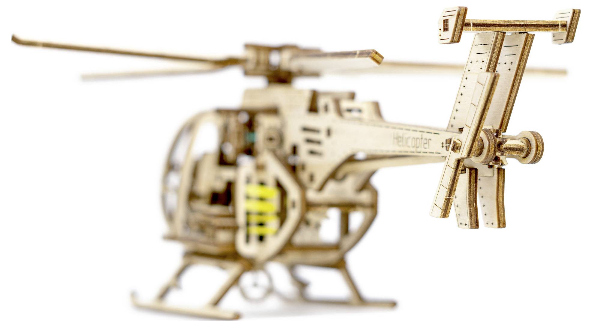 A detailed wooden model of a helicopter with visible rotor blades and structural details.