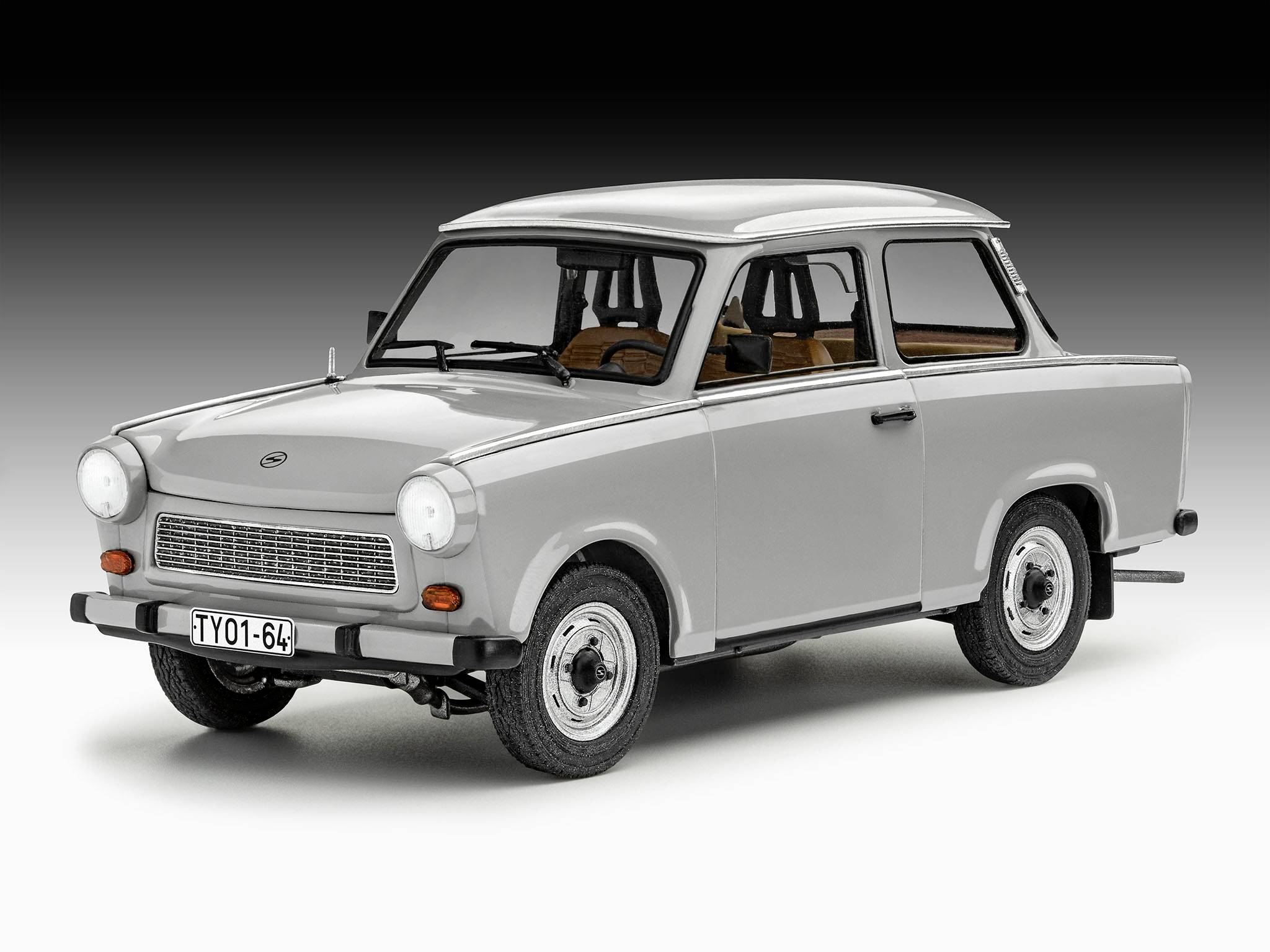 A grey classic car with a square shape and traditional headlamps, depicted in a studio against a neutral background.