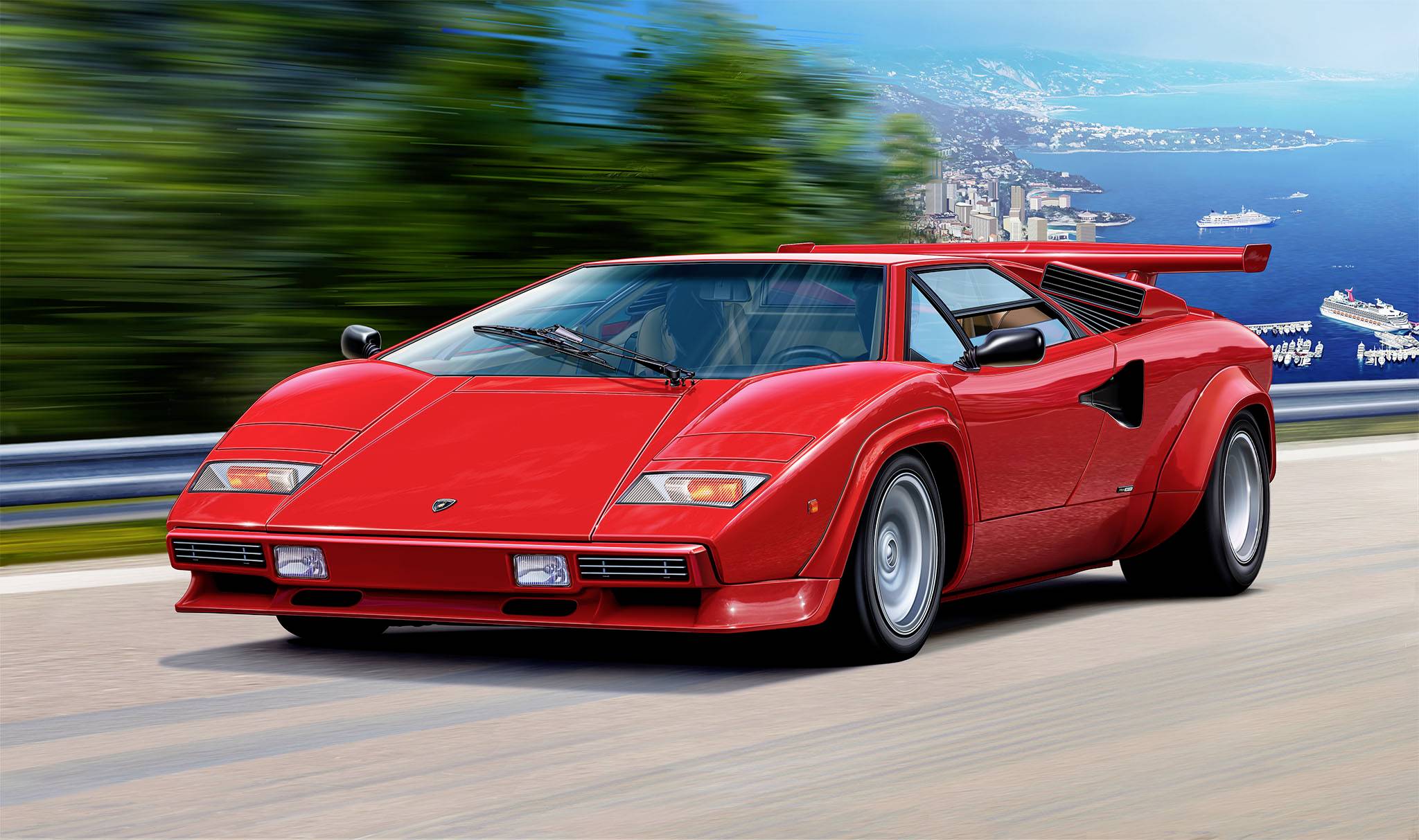 A red sports car is driving along a coastal road. The sea and blurred trees are visible in the background, suggesting movement.