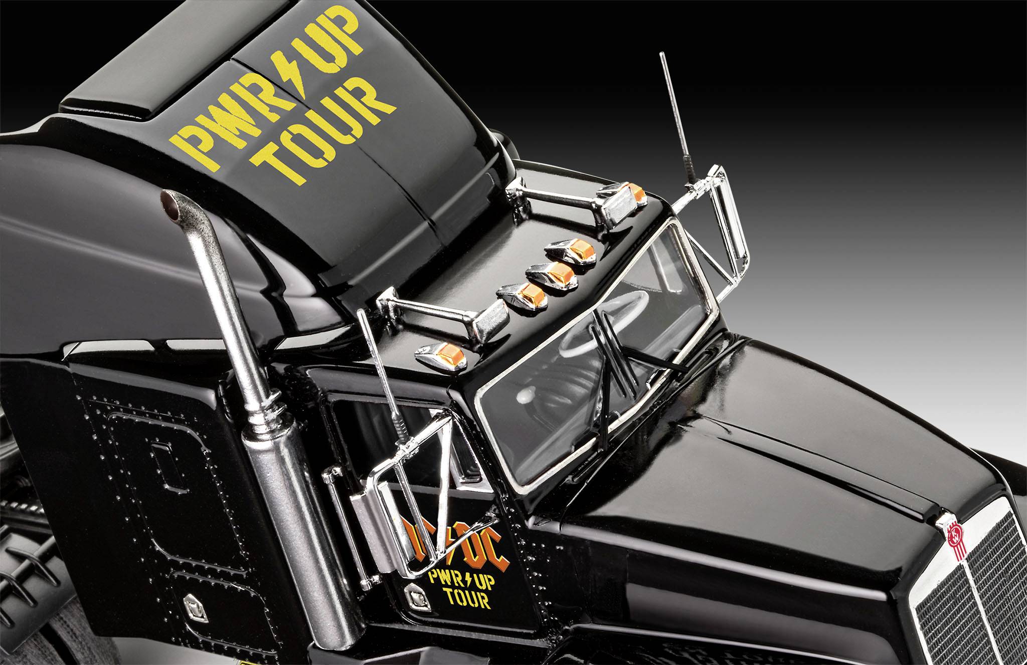 Black lorry with yellow 'PWR UP TOUR' print on the bonnet and side. Overhead view reveals reflective parts and details.
