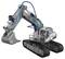 Grey model of a tracked excavator with blue and white details. It has movable parts such as a boom and a bucket.