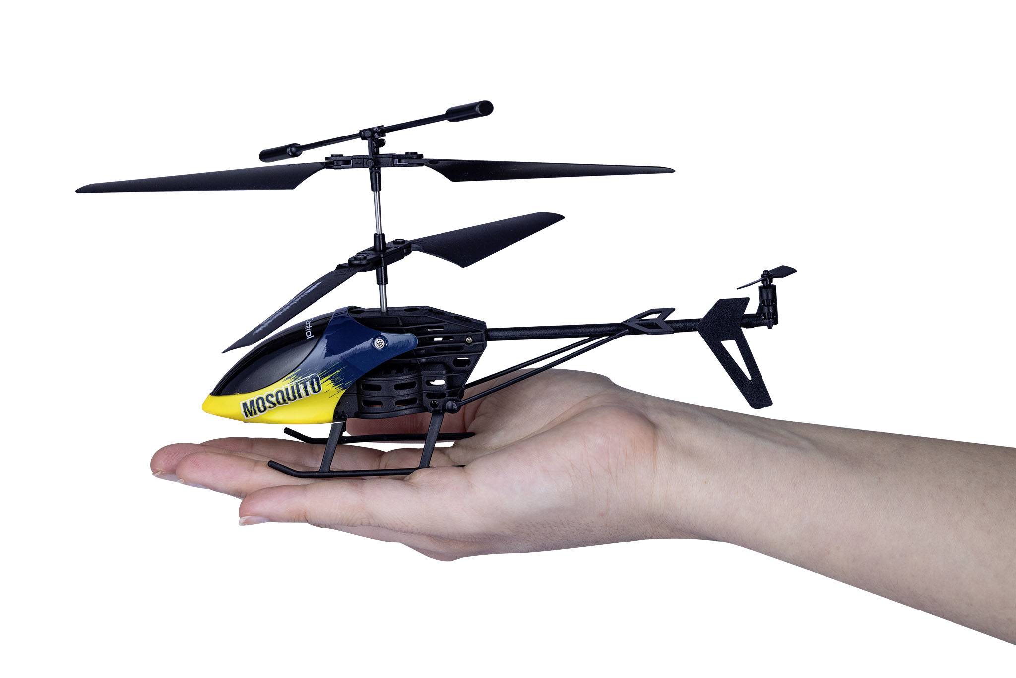 A hand is holding a small remote-controlled helicopter with a yellow fuselage and 'MOSQUITO' printed on it.
