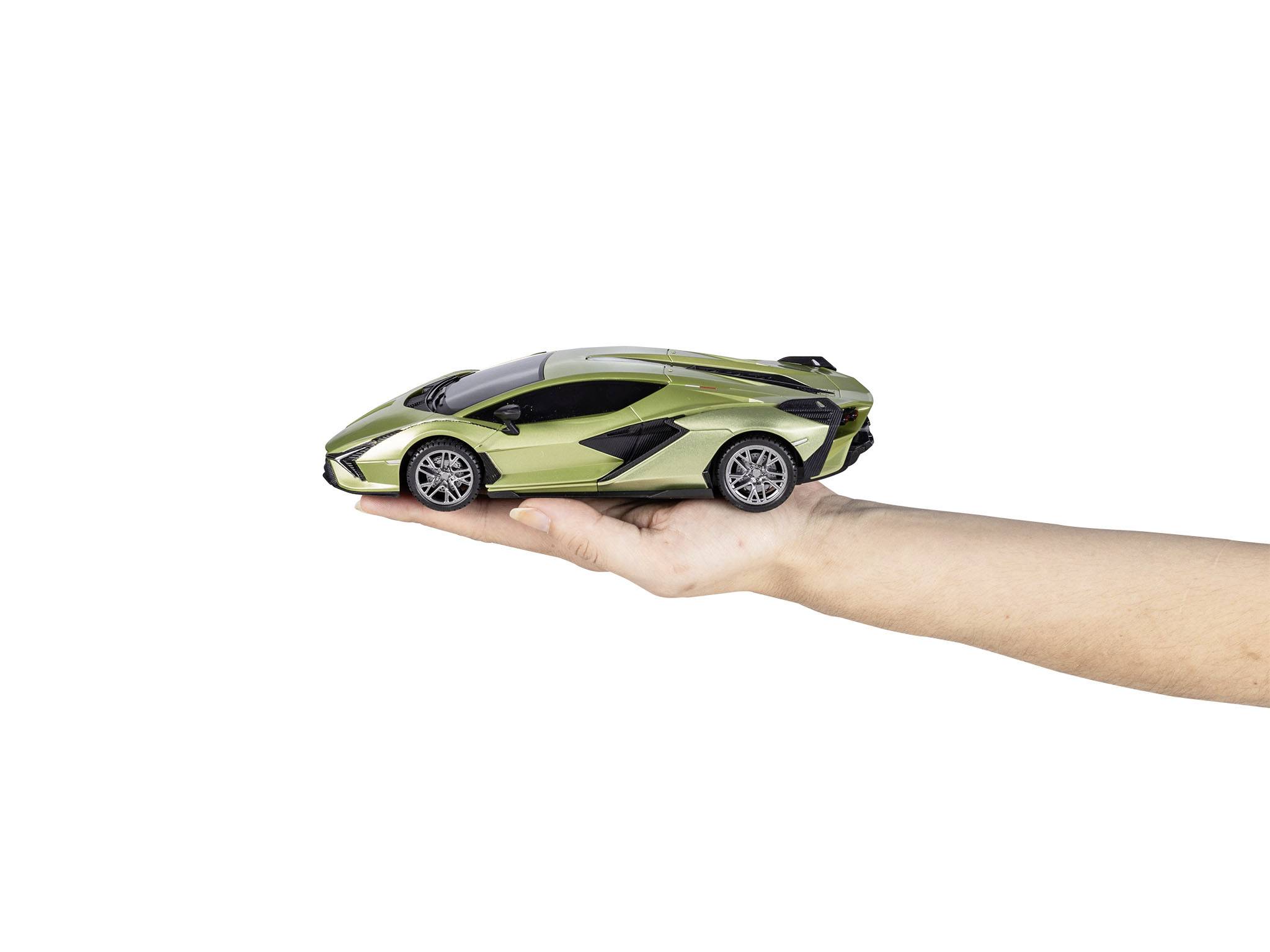A hand is holding a small model car in metallic green. The car is meticulously designed and looks elegant and sporty.