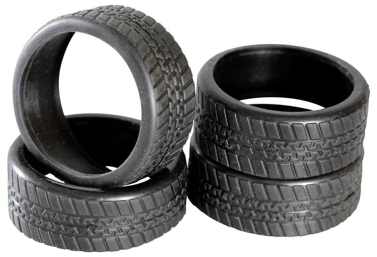 Four black tyres, stacked on top of each other, with visible tread design.