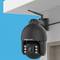 Surveillance camera mounted on a ceiling, pointing downwards. The background is blue.