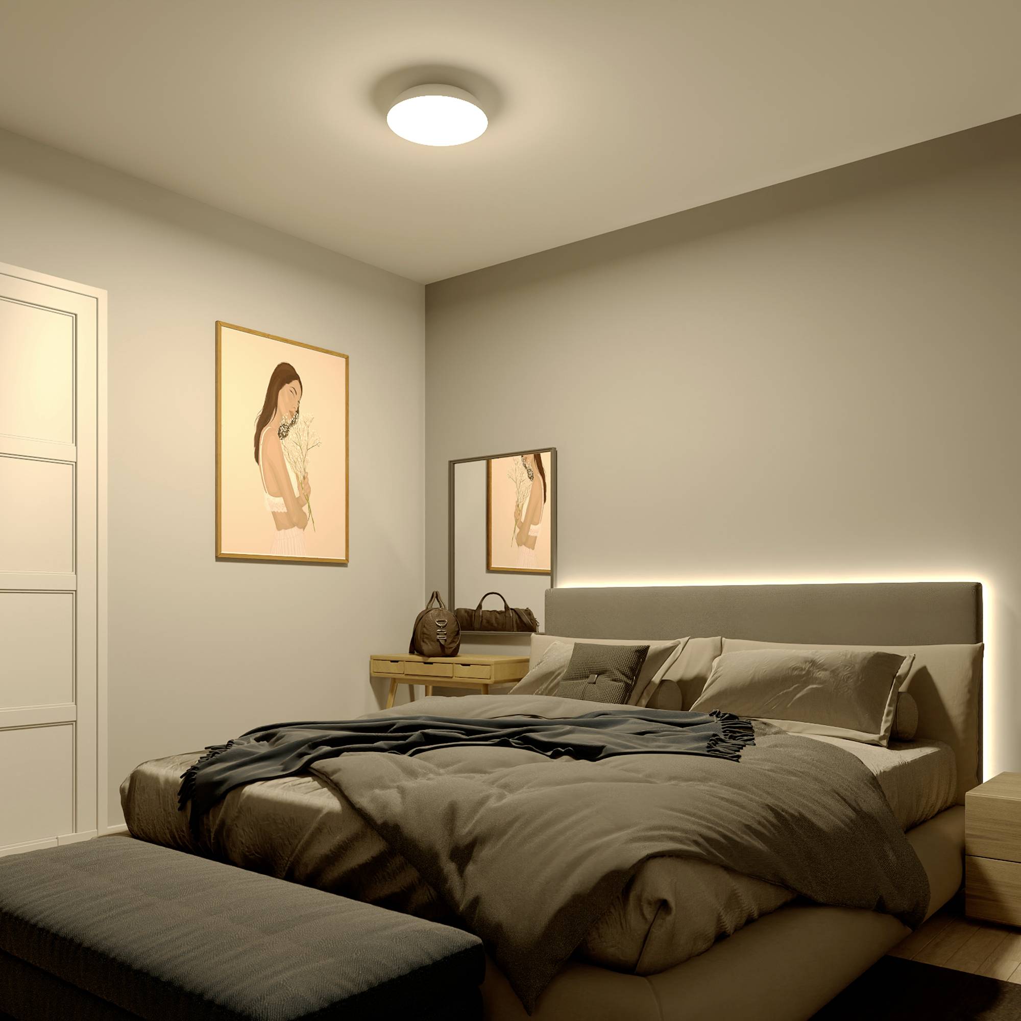 Bedroom with a double bed, bedside table lamps, artwork on the walls and subdued lighting, creating a cosy atmosphere.