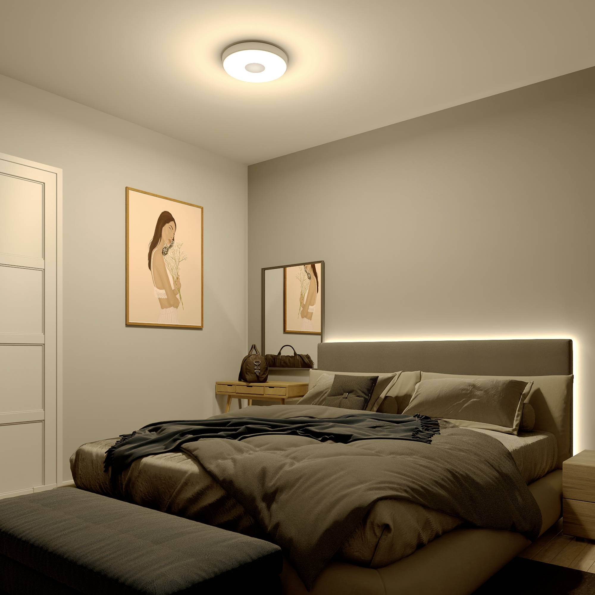 Bedroom with a double bed, beige throws and cushions. A bedside table with a lamp stands to the side. Two portraits hang on the wall.
