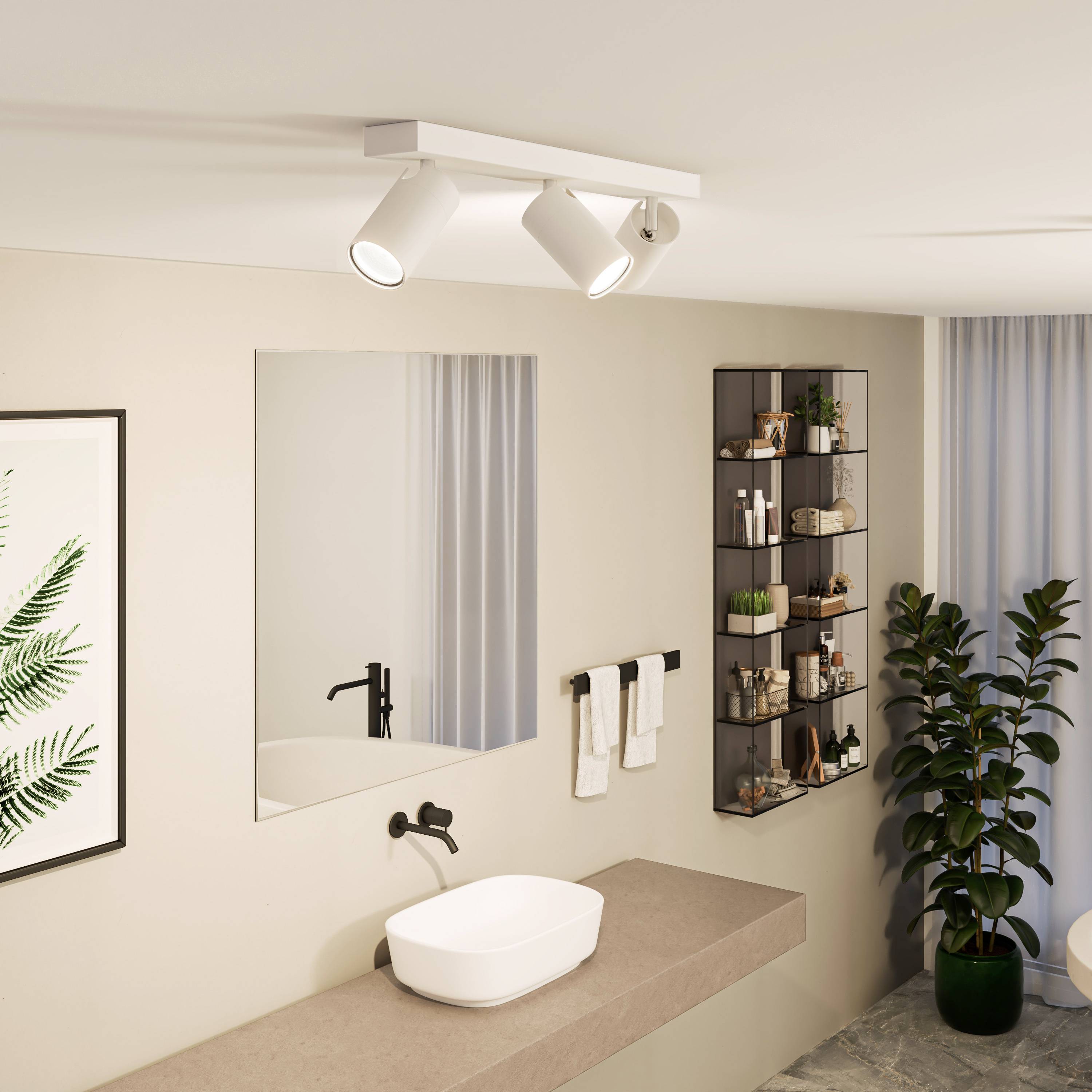 Modern bathroom with washbasin, mirror, towels, wall shelf with toiletries and plants, well-lit.