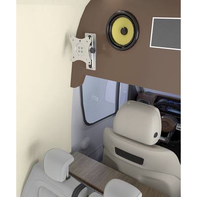 Motorhome interior with a view of the cockpit. Beige seats, a speaker on the wall and a mounting bracket for a screen are visible.