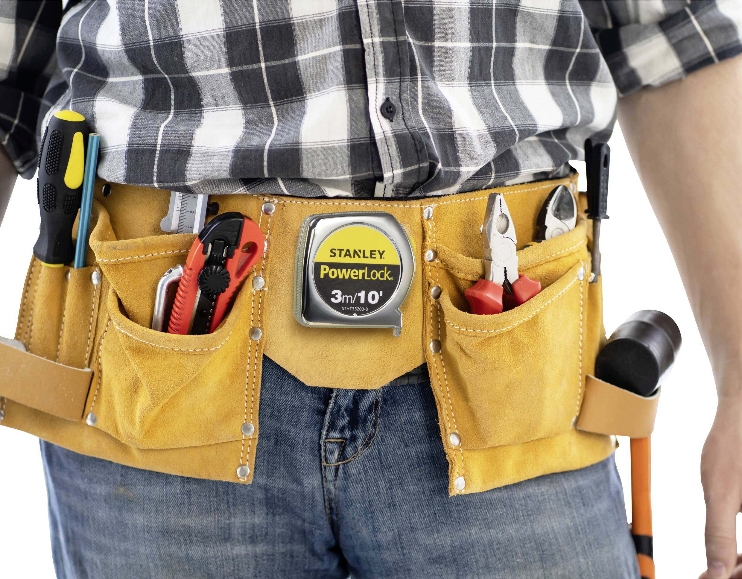 A person wearing a checked shirt is carrying a tool belt with various tools such as a screwdriver, tape measure, pliers, and hammer.