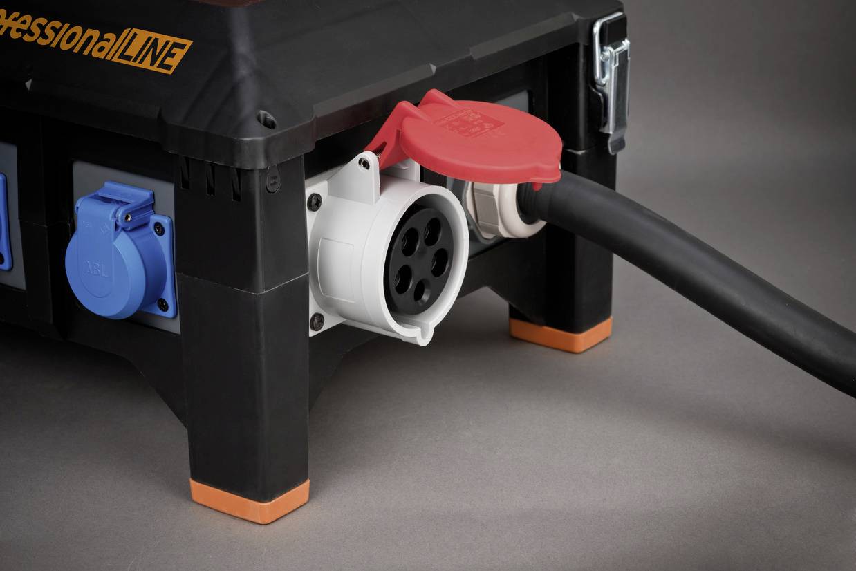 A black electric socket with an attached cable and red protective caps. There are blue socket slots on the side.